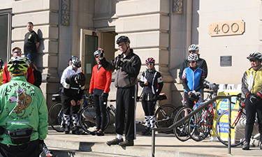Des Moines Mayor Frank Cownie (center, wearing gray) addresses a crowd before the Mayor’s Annual Ride for Trails.