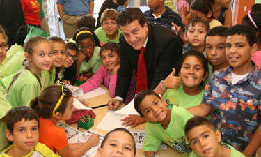 Mayor Carlos Hernandez visits with children in his community. Hernandez spearheaded specialized programs for at-risk youth that address all aspects of healthy living.