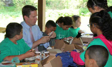 Rep. Bob Dold (R-IL-10) has lunch with children at Waukegan Park District during  a 2015 Park Champion event to check out its Summer Food Service Program. 