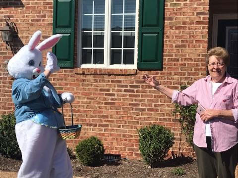 Lynn Hoy in an Easter bunny costume visiting older adults in the community