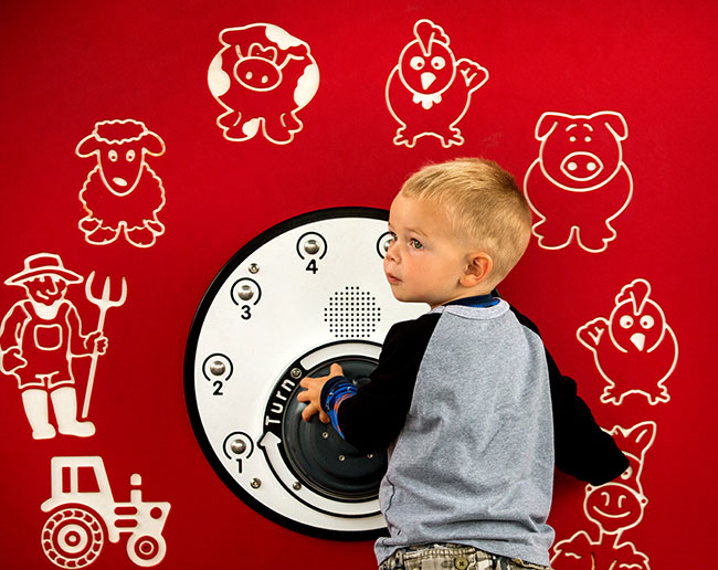 A child uses a playground with sensory elements