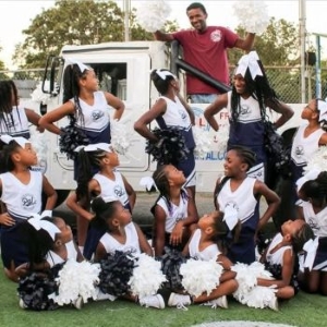 North Little Rock youth cheerleading program poses in front of truck