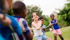 Kids play tug-of-war outside