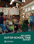 Cover of the 2021 Out-of-School Time Report with a group of children throwing leaves in the air.