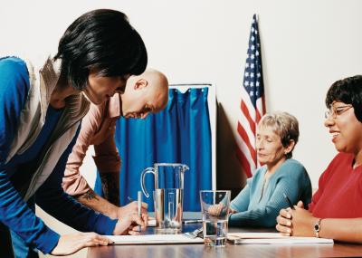 photo of people preparing to vote