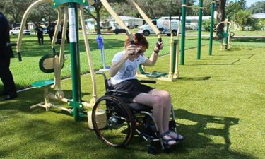 A disabled fitness enthusiast tries out the accessible equipment in St. Petersburg, Florida.