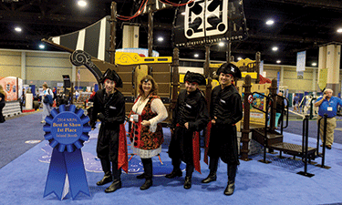 Playcraft Systems took home the first-place blue ribbon for an island booth thanks to their popular pirate ship playground complete with costumed staffers and pirate hat giveaways.