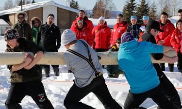 Team Yukon competes in the pole push, a Dene game in which two teams of four athletes attempt to push each other out of the competition ring.