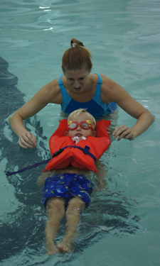 Cole Moody, 4, experiences swimming in a life jacket under the watchful eye of City of Myrtle Beach, South Carolina, Parks and Recreation Water Safety Instructor Lauren Mynhier.