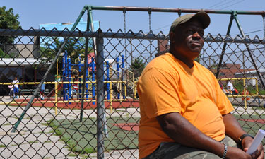 Nelson Playground and Waterloo Pool Director Anthony Washington sits near the basketball courts on a hot August day in North Philadelphia.