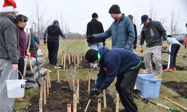 Jacob Schaffner (center, standing) directs his team of helpers during the December 2014 planting of monarch waystation No. 9712 at NRPA headquarters in Ashburn, Virginia. 