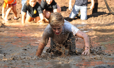 Kids indulge their natural attraction to messy fun during a Mud U event at Lake McMurtry in Stillwater, Oklahoma.