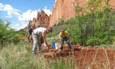Volunteers, like those shown caring for the Garden of the Gods Park site, became caretakers of various Colorado Springs Parks sites, a commitment that continues despite increased funding. 