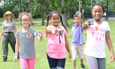 Fourth grade students from Samuel W. Tucker Elementary School in Alexandria, Virginia, show off their Every Kid in a Park passes.
