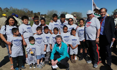 Interior Secretary Sally Jewell (crouching, front) with Anahuak Youth Sports Association members, Raul Macias (second from right), and Robert Garcia (far right) at Los Angeles State Historic Park.